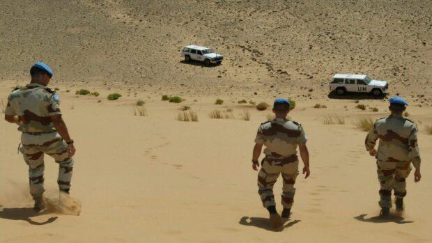 French soldiers of the United Nations mission for the organization of a referendum in Western Sahara (MINURSO) walk in an almost desert landscape toward their vehicles at the Oum Dreyga observation site, 450 kms south of El Ayoun, the region's main city, 09 May 2004. The Oum Dreyga observation site is one out of nine military sites set up by the MINURSO in 1991, in charge of monitoring a ceasefire reached by Morocco and the Western Sahara's Polisario Front the same year, and one out of four sites on the Moroccan side of a huge, fortified 2,000-kilometer-long sand wall built by the Moroccan army from 1982 to put an end to the Polisario Front's deadly raids. The Polisario Front is a rebel movement backed by Algeria in its fight for independence from Morocco of the former Spanish colony. AFP/PHOTO/ABDELHAK SENNA (Photo credit should read ABDELHAK SENNA/AFP/Getty Images)
