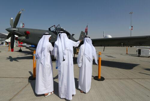 Men look at an US-made Archangel intelligence, surveillance and reconnaissance plane dislayed at the Dubai Airshow on November 9, 2015, in the Gulf Emirate. AFP PHOTO / MARWAN NAAMANI / AFP PHOTO / MARWAN NAAMANI